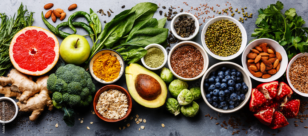 Obraz na płótnie Healthy food clean eating selection: fruit, vegetable, seeds, superfood, cereal, leaf vegetable on gray concrete background w salonie