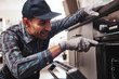 Don't delay with repair. Close-up of repairman examining oven