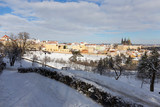 Fototapeta Do pokoju - Snowy Prague City with gothic Castle from Hill Petrin in the sunny Day, Czech republic