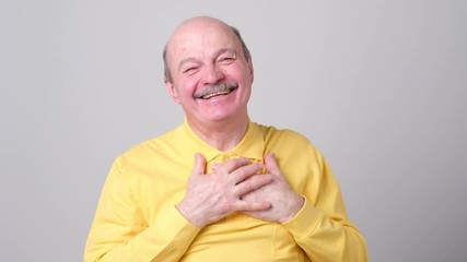 Poster - Happy senior man holding palm on heart and smiling thankful receiving compliment