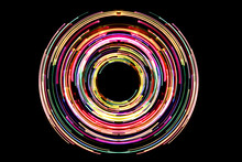 Abstract Neon Circle Lines With Empty Copy Space Inside Isolated On Black Background. Colorful Led Lights Long Exposure Rotation Photo.
