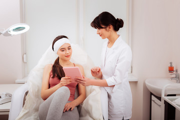 Nice attractive woman taking a modern tablet