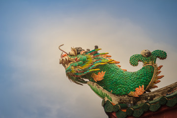 Beautiful dragon fish statue on the roof of Chinese temple.