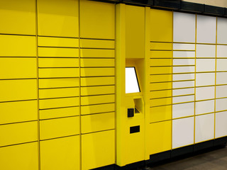 Electronic Locker, Yellow automated parcel terminal (parcel locker, post terminal, E-Locker) on the street with empty screen for mockup, home delivery. 