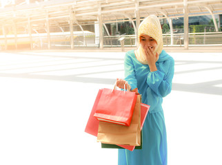 Muslim women hold paper bag are happy to shopping