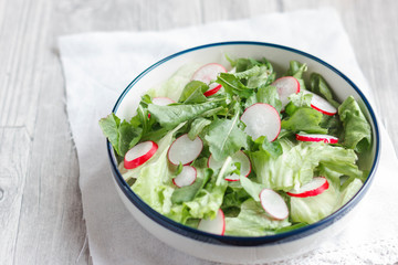 Wall Mural - Dietary food for fitness. Radish, Lettuce and Arugula Salad