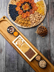 Wall Mural - Healthy food. Selection of good carbohydrate sources, high fiber rich food. Low glycemic index diet. cereals, legumes, nuts, dried fruits. Wooden background copy space