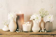 White Flowers In Neutral Colored Vases And Candles