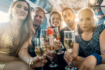 Wall Mural - Crowd of party people in a limo with drinks