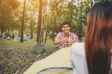 Hiking man sitting to set up a tent in national park Travel lifestyle success concept adventure