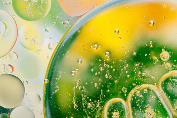 Water oil bubble macro abstract background flow liquid green yellow white colors