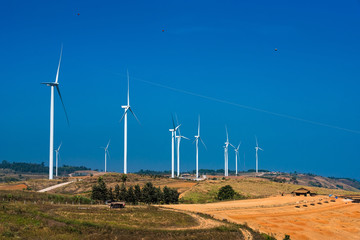 Power of wind turbine generating electricity clean energy with cloud background on the blue sky.Global ecology.Clean energy concept save the world.