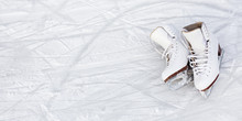 Close Up Of Figure Skates And Copy Space Over Ice Background With Marks From Skating Or Hockey