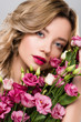 © LIGHTFIELD STUDIOS - beautiful blonde woman posing with spring Eustoma flowers bouquet