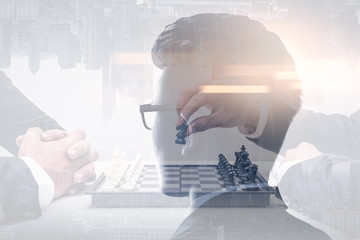 The double exposure image of the businessman thinking overlay with chess game and cityscape image and white copy space. the concept of strategic, planning, management, intelligence and education.