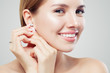 © artmim - Closeup portrait of jewelry model. Beautiful woman with diamond earrings and ring, face closeup
