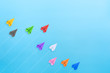 © Worawut - Multicolored paper planes on blue background, Business competition concept with copy space