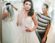 © Nejron Photo - Beautifu bride choosing wedding dress in a wedding salon
