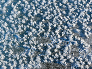 relief texture of ice and snow on a frozen river in a highland sunset