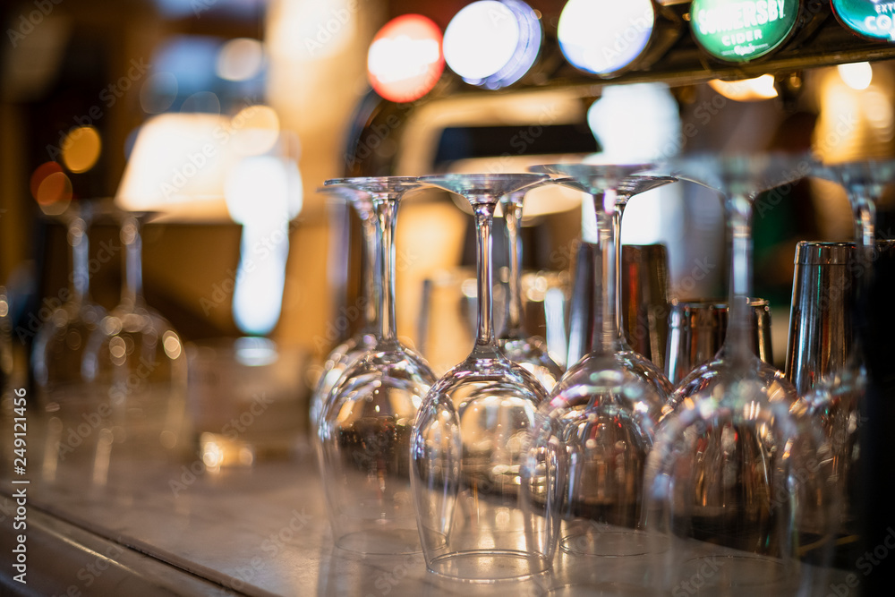 Empty Wine Glasses on a Bar Counter - obrazy, fototapety, plakaty 