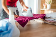 © Dragana Gordic - Young Smiling Woman Ironing Clothes On Ironing Board At Home