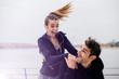 © BGStock72 - Male coach helping young woman exercising at outdoors
