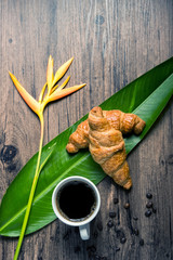 coffee break, White coffee cup, croissants on wood table background, selective focus. Breakfast concept