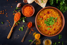 Indian Dal. Food. Traditional Indian Soup Lentils.  Indian Dhal Spicy Curry In Bowl, Spices, Herbs, Rustic Black Wooden Background. Top View. Authentic Indian Dish. Overhead. Flat Lay