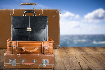 Retro suitcase with travel objects  on sea background