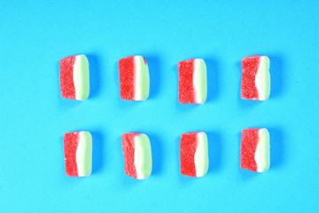 Wall Mural - group of jelly candies watermelon on blue background