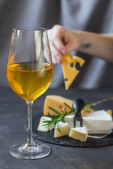 white wine in a transparent glass and snack. food background. top photo