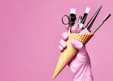 Manicure and pedicure abstract concept. Hand hold waffles cone with instruments for nails salon and spa brush nail file
