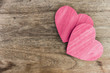 wooden heart love symbol pink paint on wood table with copy space.