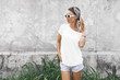 © Alena Ozerova - Woman in white t-shirt on grey background
