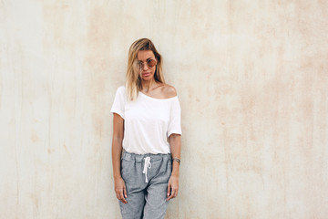 Wall Mural - Woman in white t-shirt on beige background