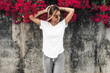 © Alena Ozerova - Woman in white t-shirt on grey background with spring flowers