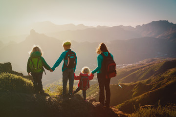 Mother with kids travel in mountains, family hiking in nature