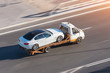 © aapsky - Recovery truck to transport a car on the highway in the city