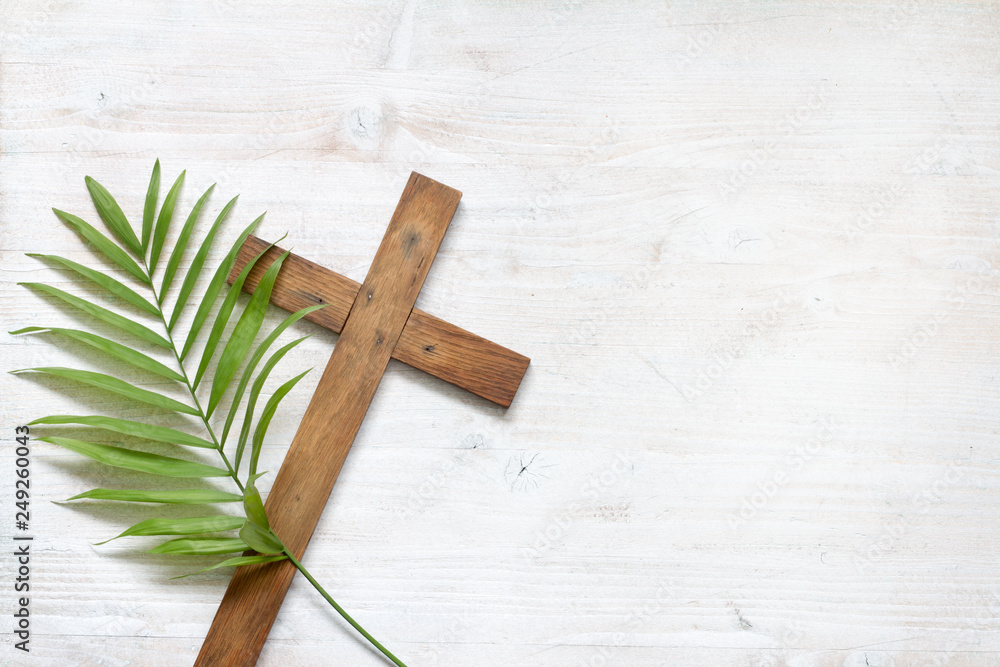 Cross and palm on wooden white background easter sign symbol concept - obrazy, fototapety, plakaty 
