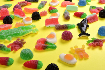 Wall Mural - elevated view of jelly candies collection on yellow background