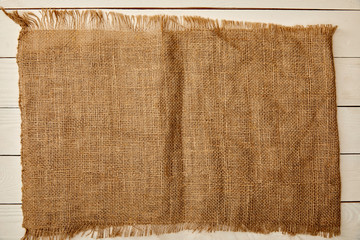 piece of brown sackcloth on white wooden surface