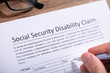 © Andrey Popov - Person Filling Social Security Disability Claim Form