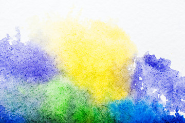 Poster - top view of blue, yellow, purple and green watercolor spills on white background