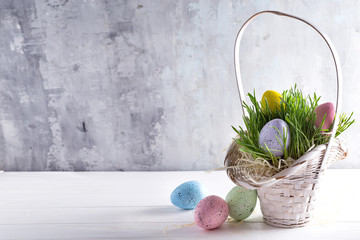 Sticker - Easter basket filled with colorful hand painted Easter Eggs on grass over a light background