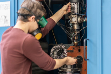 technician install welding machine at the factory b