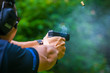 © NVB Stocker - Shooting from a pistol. Reloading the gun. The man is aiming at the target