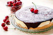 Bird's Milk Souffle Cake, Covered With Chocolate Glaze And Decorated With Ripe Juicy Cherries