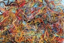 Colorful Tangled Threads On Blue Background. Closeup.