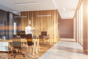 Wall Mural - Woman in gray and wooden open space office corner