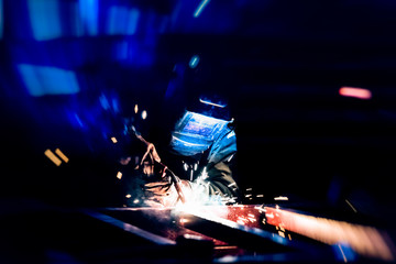 Wall Mural - Welding at the industrial factory for steel production heavy industrial. add grain filter dark tone and motion for heavy work concept.